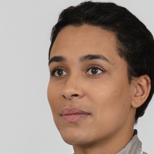 Joyful latino young-adult female with short  black hair and brown eyes