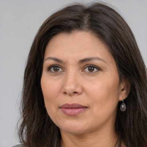 Joyful white adult female with long  brown hair and brown eyes