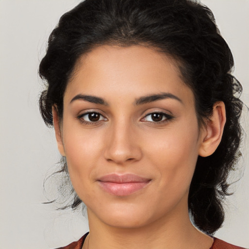 Joyful latino young-adult female with medium  brown hair and brown eyes