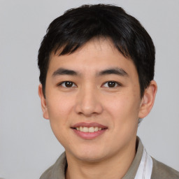 Joyful asian young-adult male with short  brown hair and brown eyes