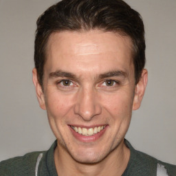 Joyful white adult male with short  brown hair and brown eyes