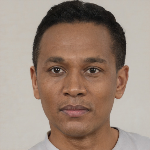 Neutral black adult male with short  black hair and brown eyes