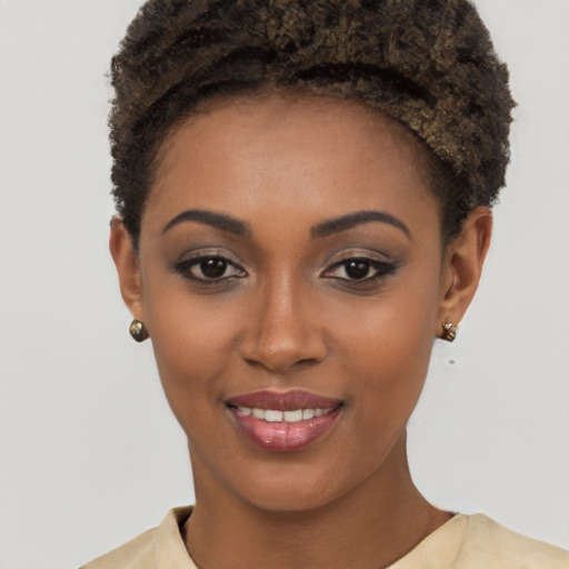 Joyful black young-adult female with short  brown hair and brown eyes