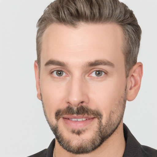 Joyful white adult male with short  brown hair and brown eyes