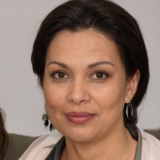 Joyful white adult female with medium  brown hair and brown eyes