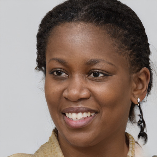 Joyful black young-adult female with medium  brown hair and brown eyes