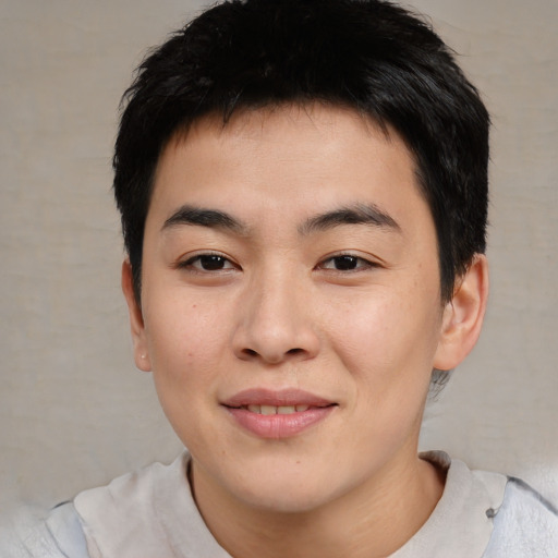 Joyful asian young-adult male with short  brown hair and brown eyes