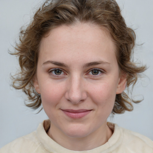 Joyful white young-adult female with medium  brown hair and blue eyes