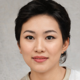 Joyful asian young-adult female with medium  black hair and brown eyes