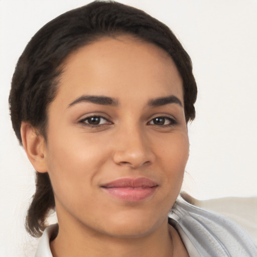 Joyful latino young-adult female with short  brown hair and brown eyes