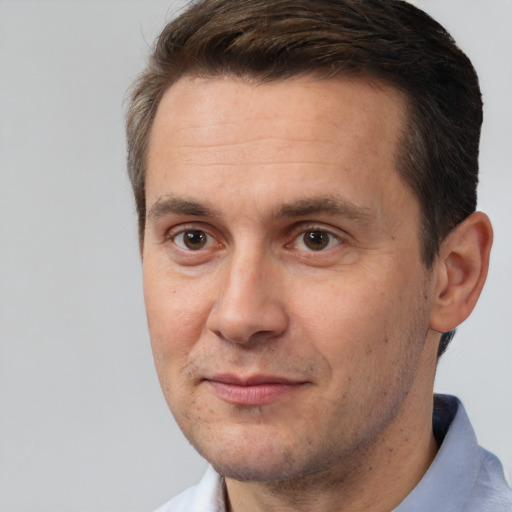 Joyful white adult male with short  brown hair and brown eyes