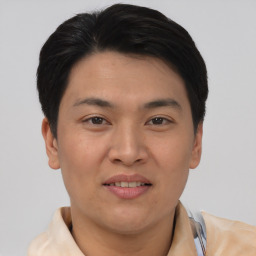 Joyful asian young-adult male with short  brown hair and brown eyes