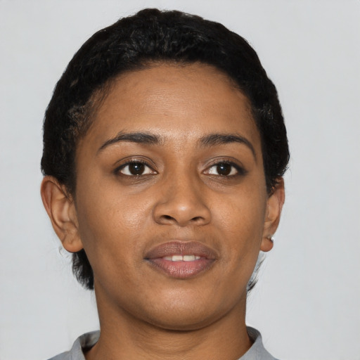 Joyful latino young-adult female with short  black hair and brown eyes