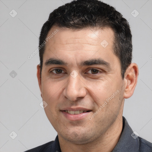 Joyful white adult male with short  black hair and brown eyes