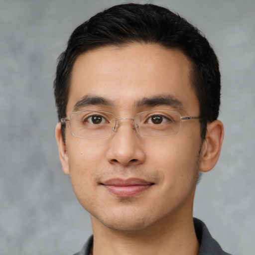 Joyful latino young-adult male with short  black hair and brown eyes