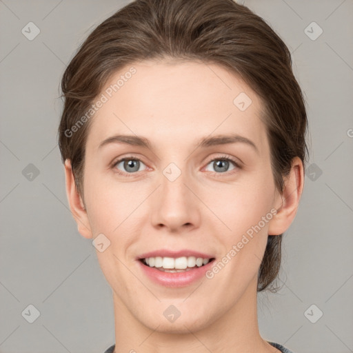 Joyful white young-adult female with medium  brown hair and grey eyes