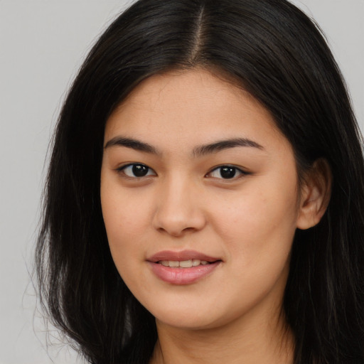 Joyful asian young-adult female with long  brown hair and brown eyes