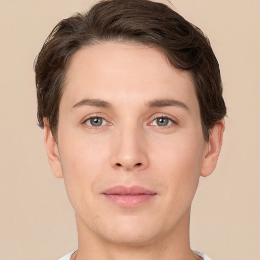 Joyful white young-adult male with short  brown hair and grey eyes