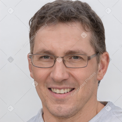 Joyful white adult male with short  brown hair and brown eyes