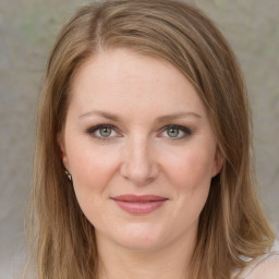 Joyful white young-adult female with medium  brown hair and green eyes