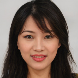 Joyful asian young-adult female with long  brown hair and brown eyes