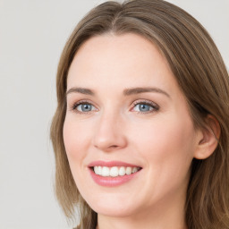 Joyful white young-adult female with long  brown hair and grey eyes