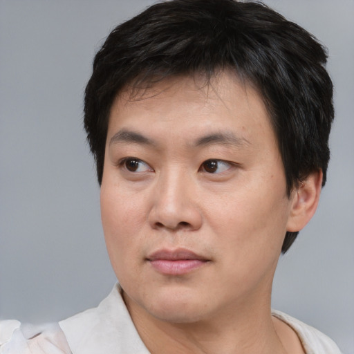 Neutral asian young-adult male with short  brown hair and brown eyes