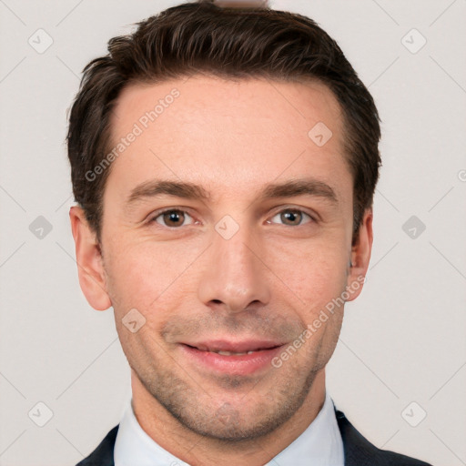 Joyful white young-adult male with short  brown hair and grey eyes