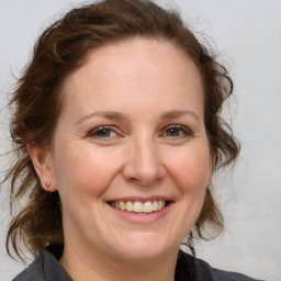 Joyful white adult female with medium  brown hair and brown eyes