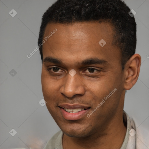 Joyful black young-adult male with short  black hair and brown eyes