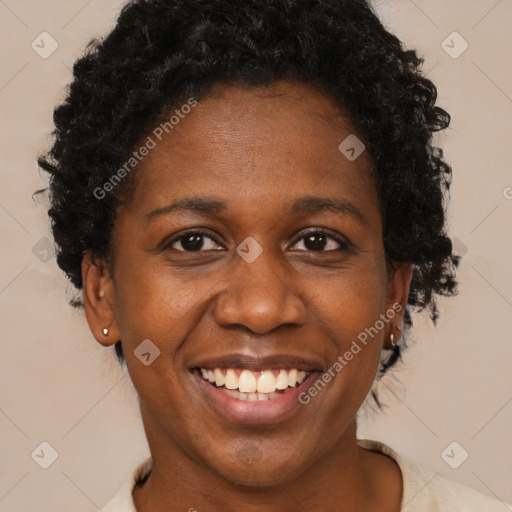 Joyful black adult female with short  brown hair and brown eyes