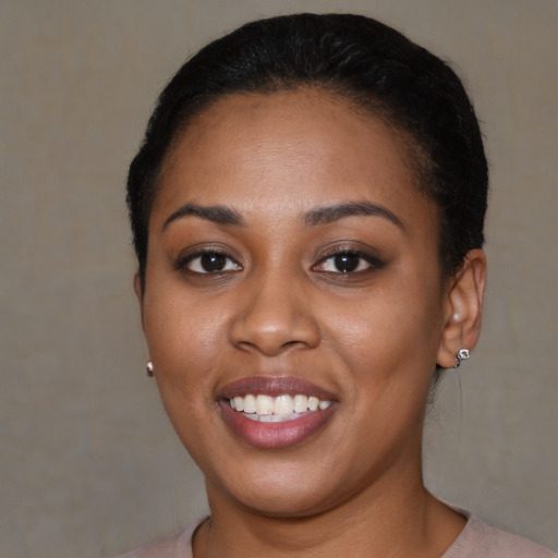 Joyful latino young-adult female with short  black hair and brown eyes