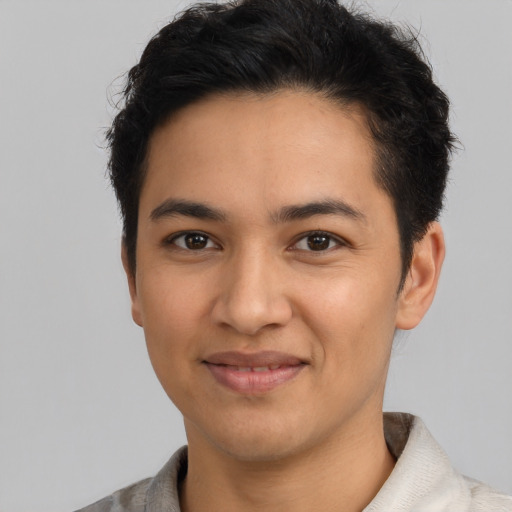 Joyful latino young-adult male with short  black hair and brown eyes