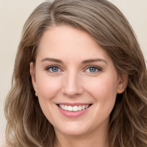 Joyful white young-adult female with long  brown hair and grey eyes