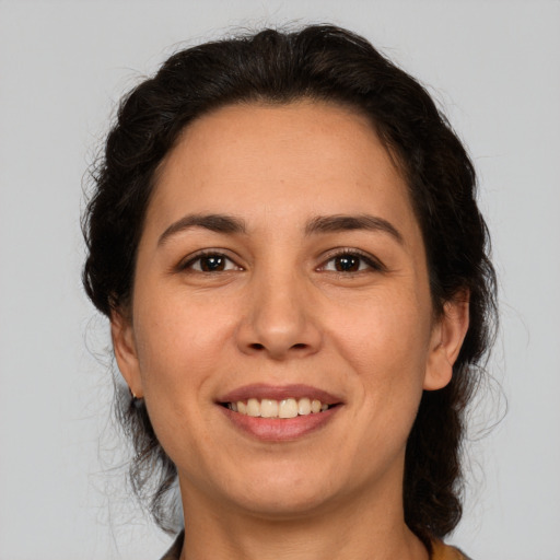 Joyful white adult female with medium  brown hair and brown eyes