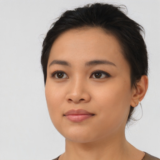 Joyful asian young-adult female with medium  black hair and brown eyes