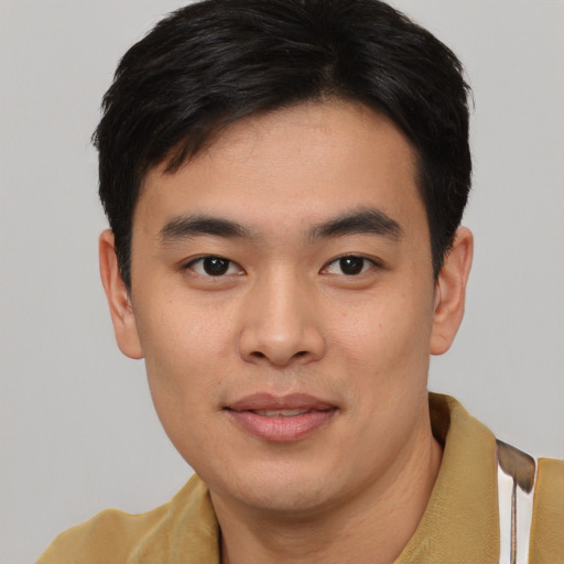 Joyful asian young-adult male with short  black hair and brown eyes