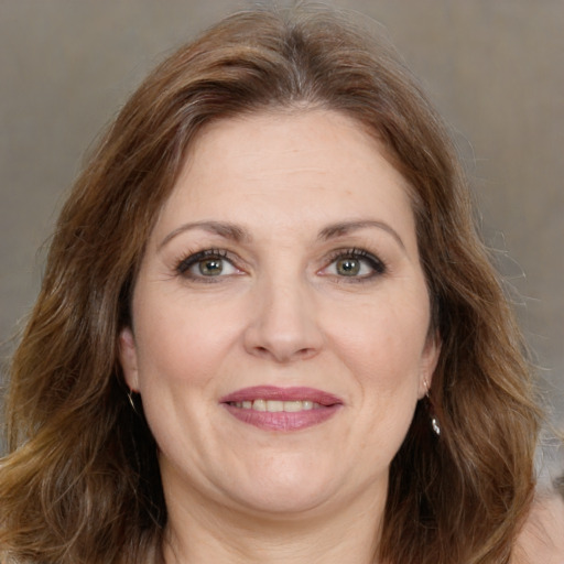 Joyful white adult female with long  brown hair and brown eyes