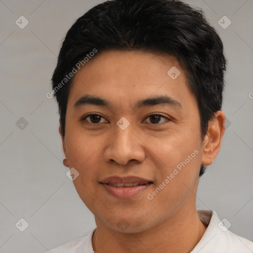 Joyful latino young-adult male with short  black hair and brown eyes