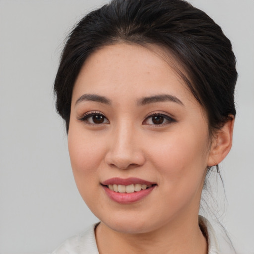 Joyful asian young-adult female with medium  brown hair and brown eyes