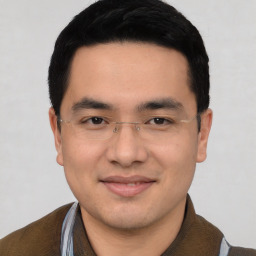 Joyful asian young-adult male with short  black hair and brown eyes