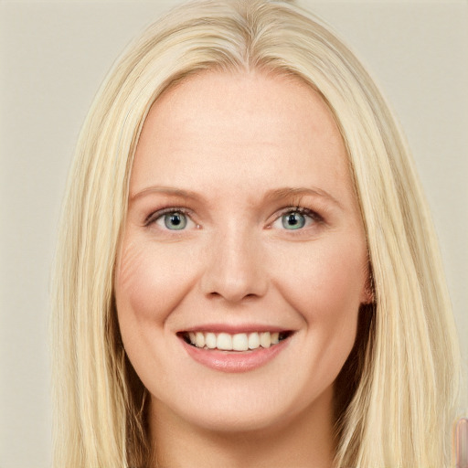 Joyful white young-adult female with long  blond hair and blue eyes