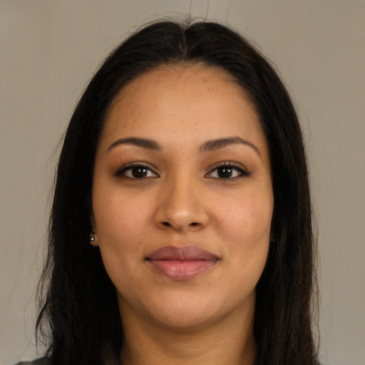 Joyful latino young-adult female with long  brown hair and brown eyes