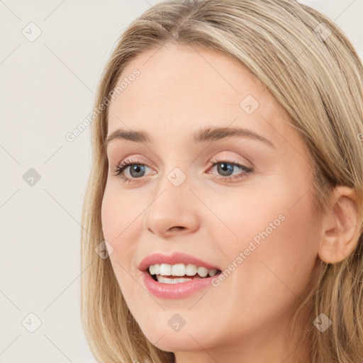 Joyful white young-adult female with long  brown hair and blue eyes