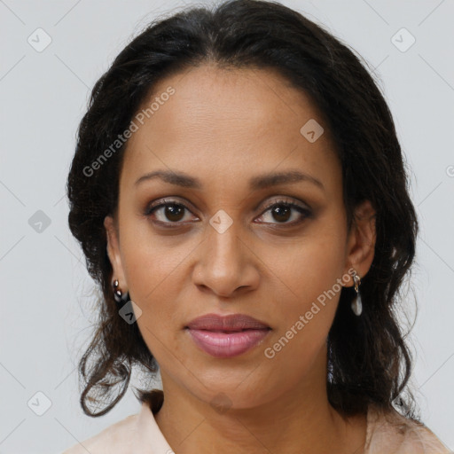 Joyful black adult female with long  brown hair and brown eyes