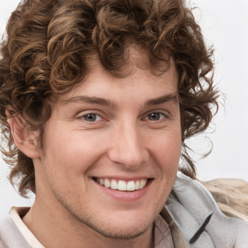 Joyful white young-adult male with medium  brown hair and brown eyes