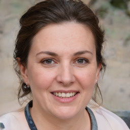 Joyful white adult female with medium  brown hair and brown eyes