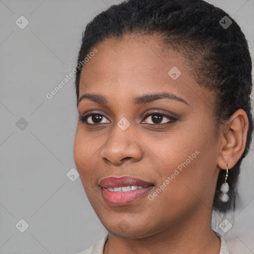 Joyful black young-adult female with short  brown hair and brown eyes