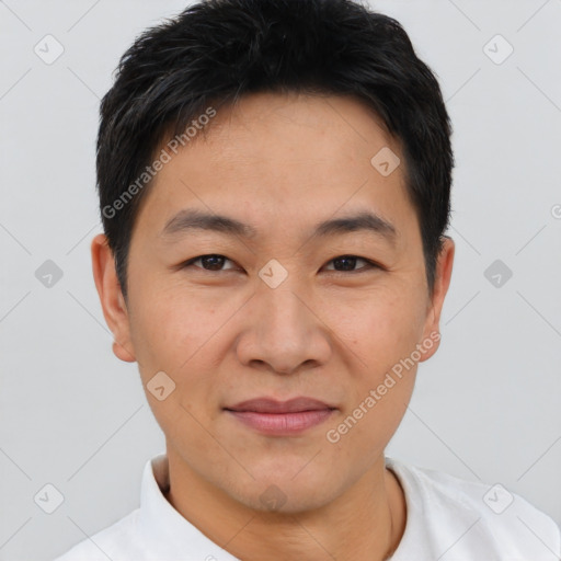 Joyful asian young-adult male with short  black hair and brown eyes