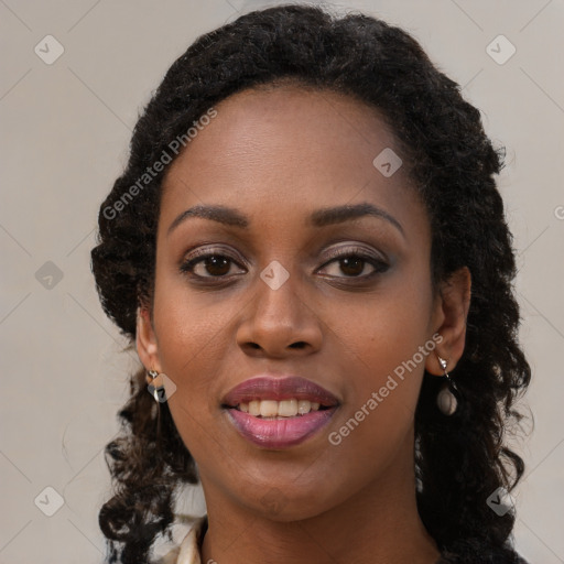 Joyful black young-adult female with long  brown hair and brown eyes